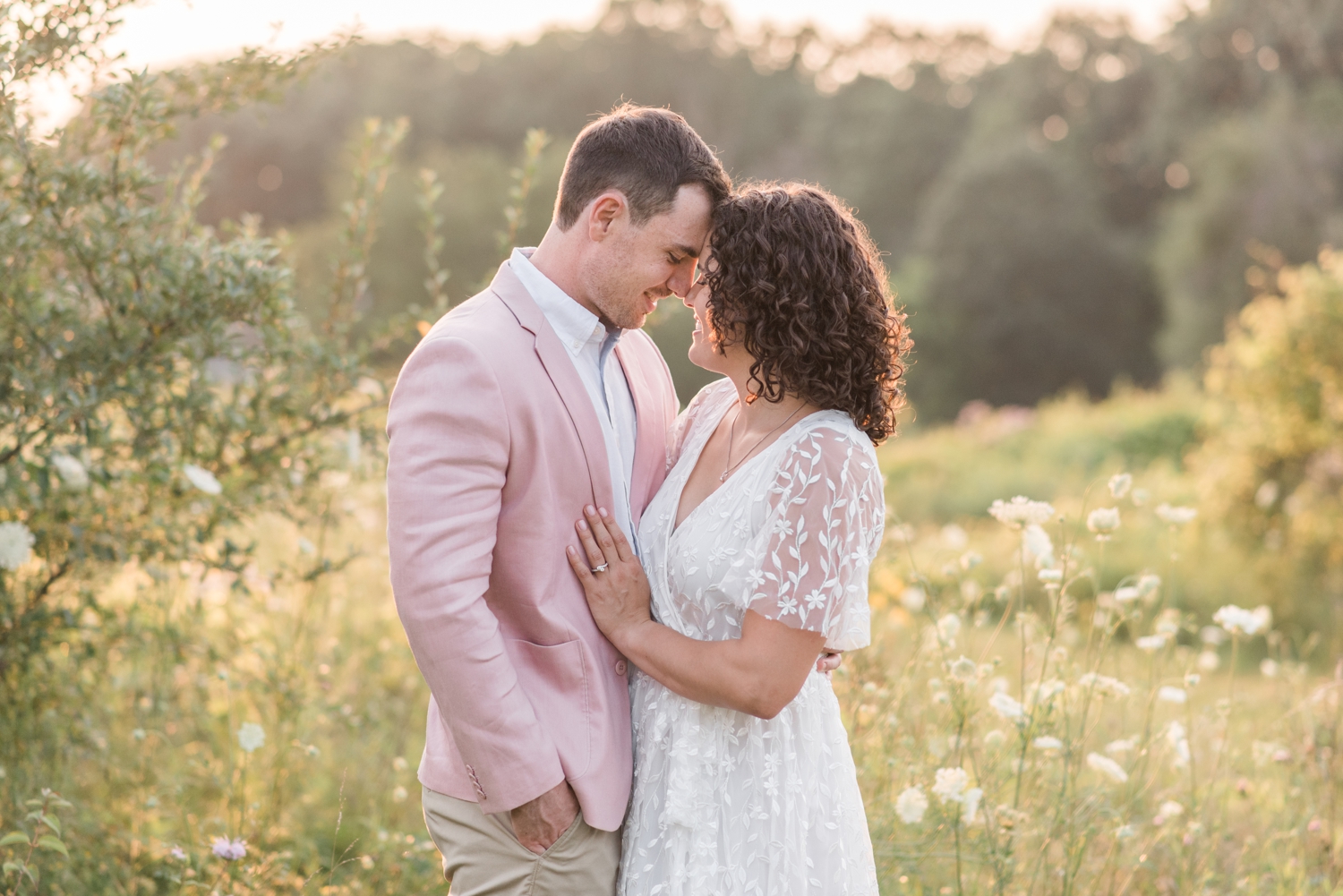 photo of engaged couple at Wildflower Sunset Picnic Engagement Session at Metea Park by Courtney Rudicel, a wedding photographer in Indiana