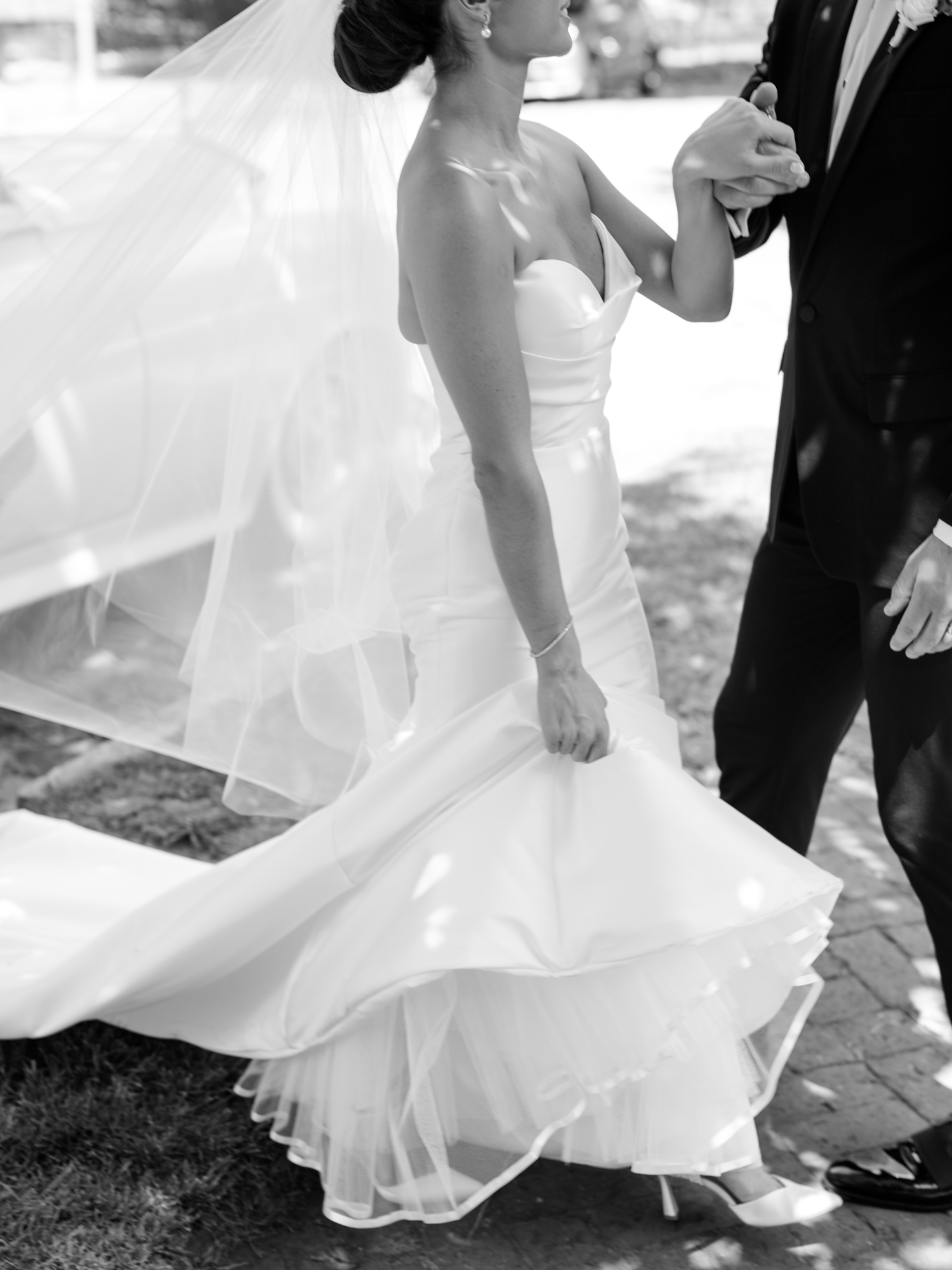Bride in a strapless gown holding a white bouquet at Bottleworks Hotel.