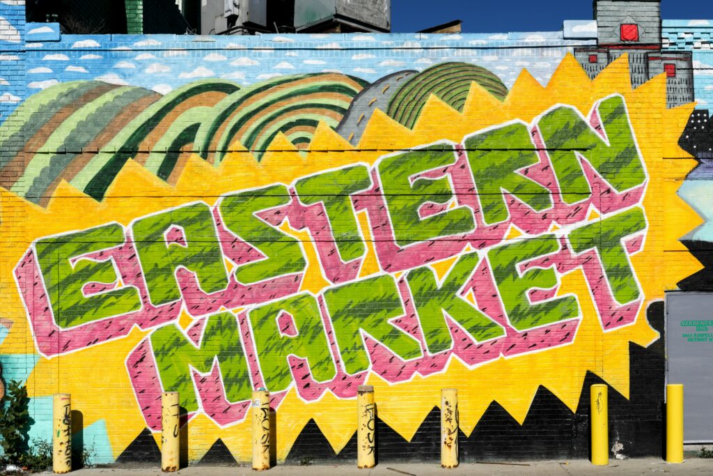 Detroit engagement photo locations at Eastern Market murals and colorful buildings. 