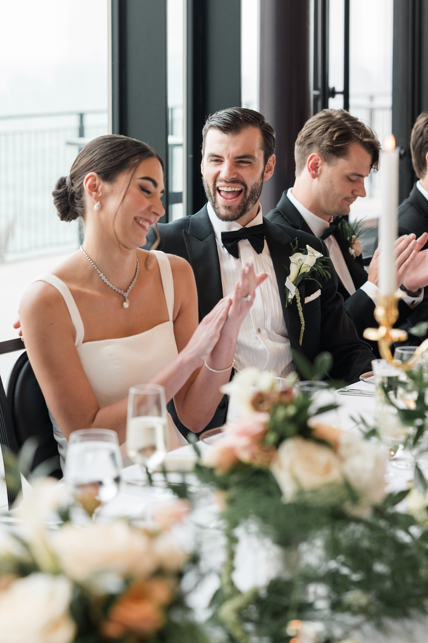 bride and groom laughing during speeches at a Detroit Wedding at The War Memorial 