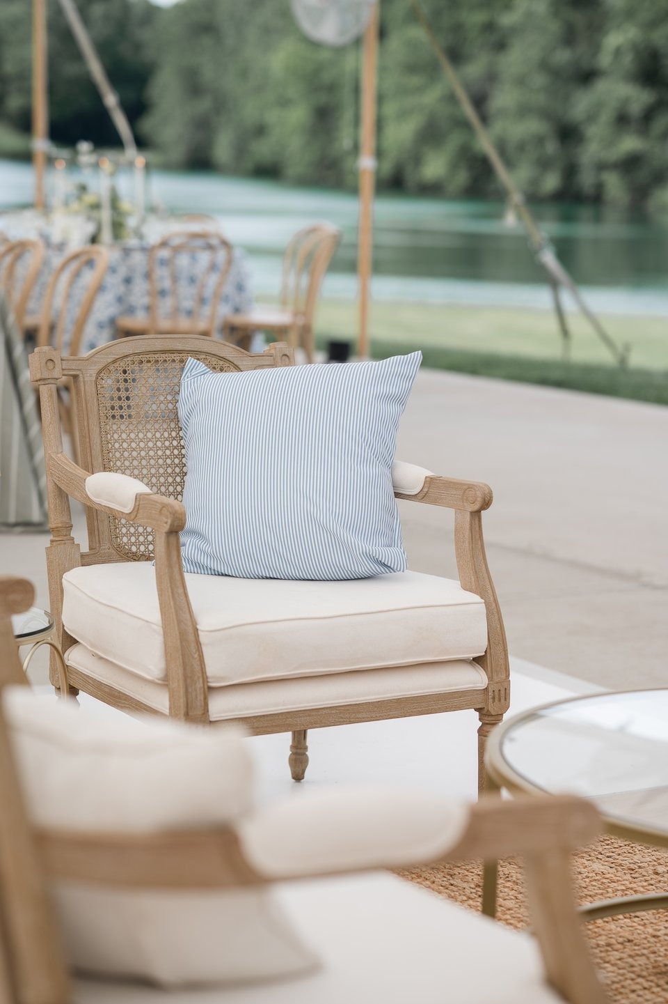closup photo of lounge chairs at a tented outdoor wedding venue