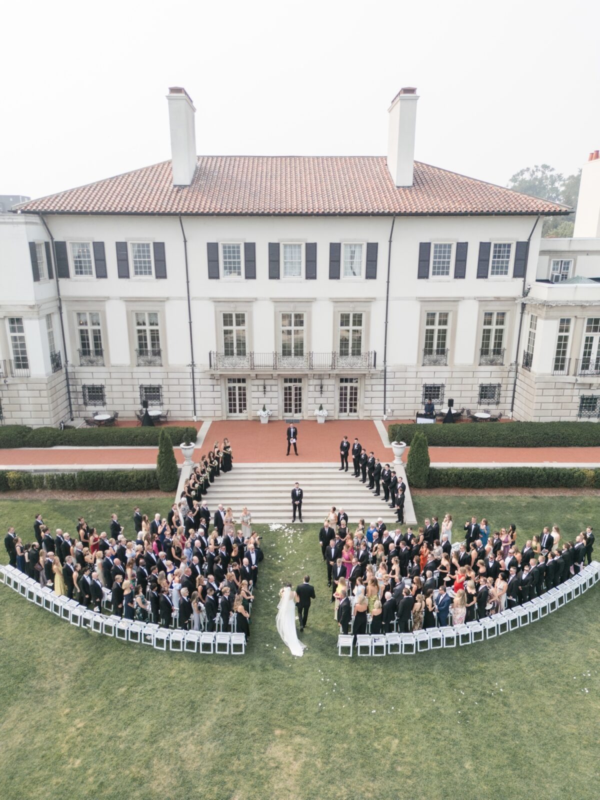 Aerial view of a bride walking down the aisle during her Detroit War Memorial wedding ceremony on the historic lawn.