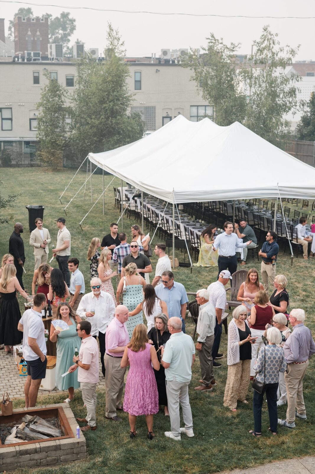 Guests talking and mingling outdoors during Jordan and Maxx's relaxed rehearsal dinner